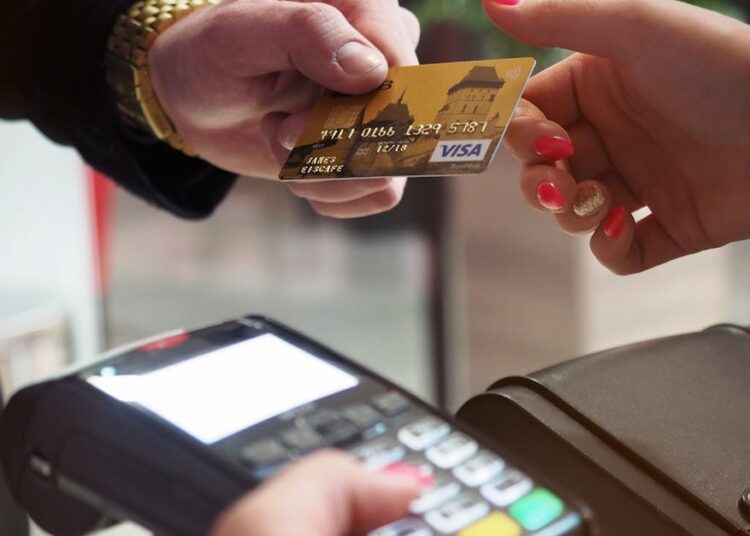 Close-up of a credit card payment being processed at a POS terminal.